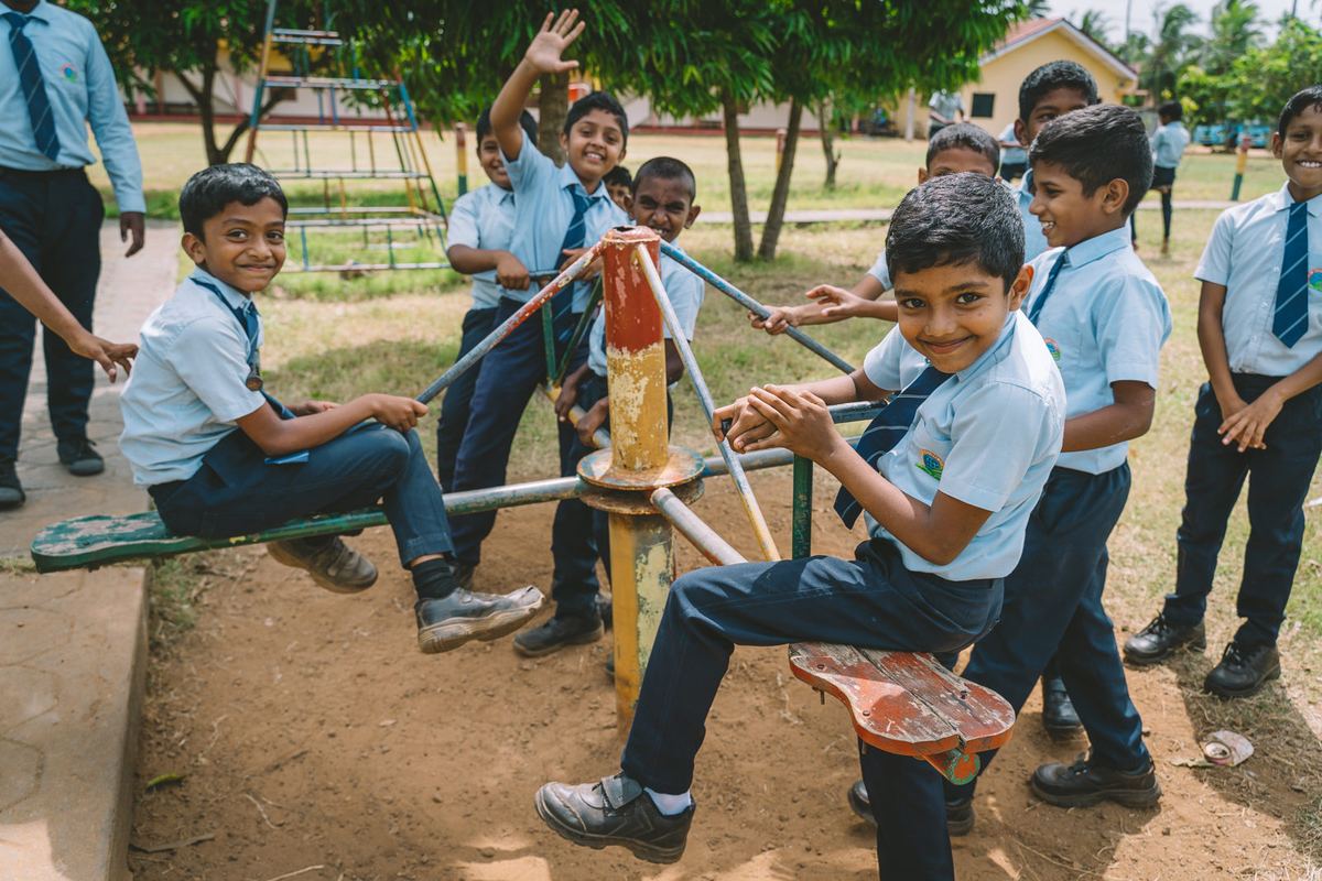 Children play on the playground at a School of Excellence