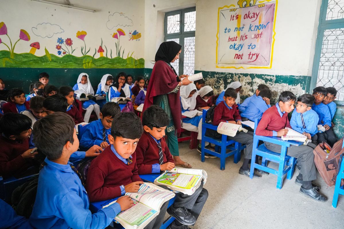 A teacher leads a lesson in a busy classroom