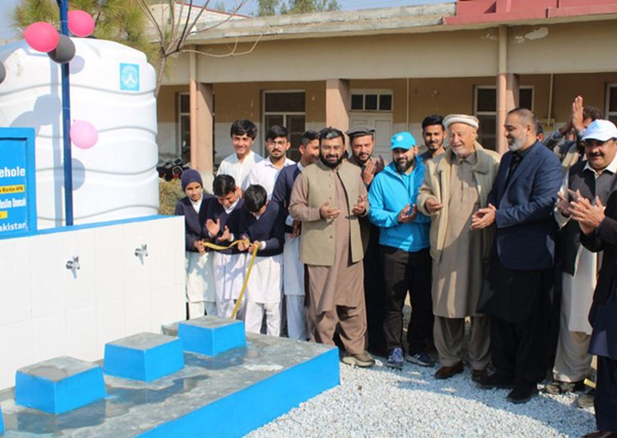 Community members gather at the opening of a solar-powered bore well